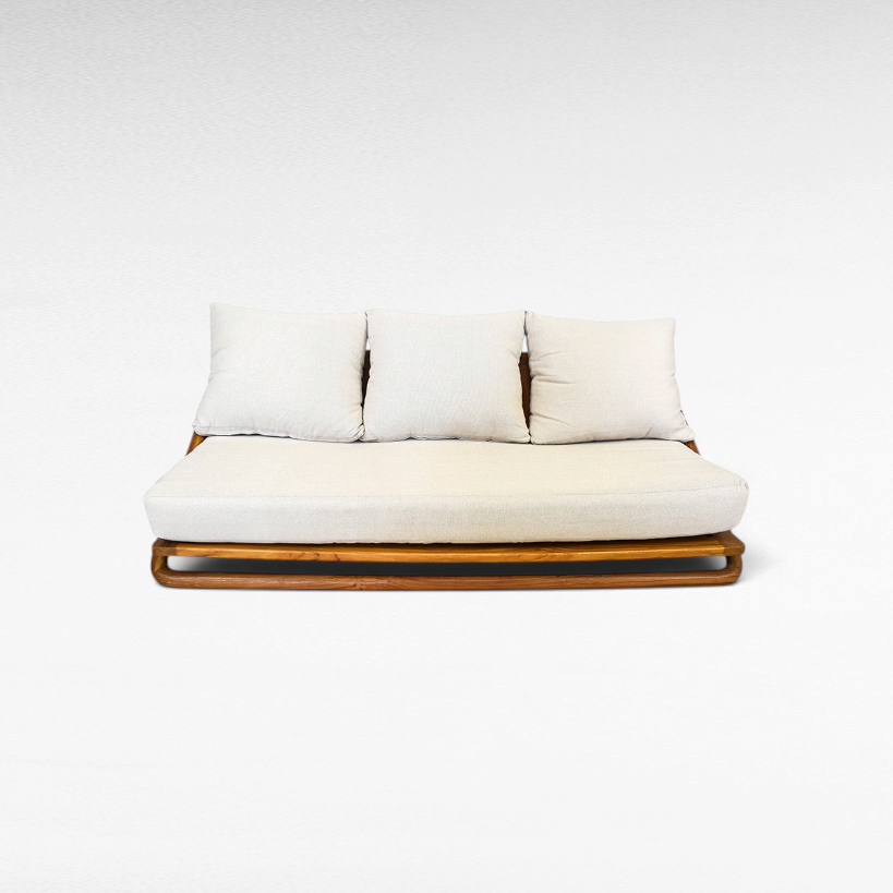 Chora Barefoot Luxury Living teak wood sofa set with a warm honey finish and plush cream-colored cushions.