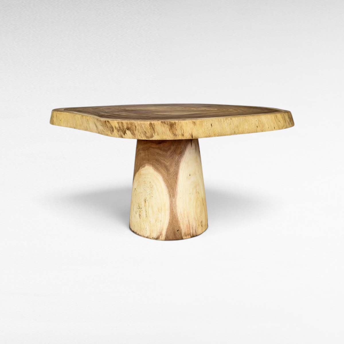 Chora Barefoot Luxury Living natural suar wood dining table with a live edge round top and a sturdy pedestal base.