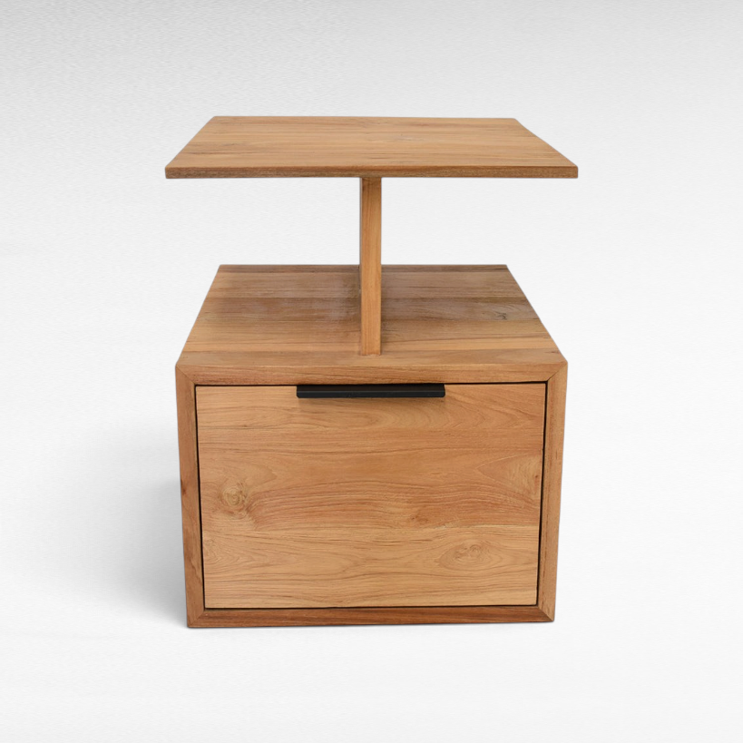 Chora Barefoot Luxury Living handcrafted teak wood bedside table with a drawer and open shelf in natural wood grain.