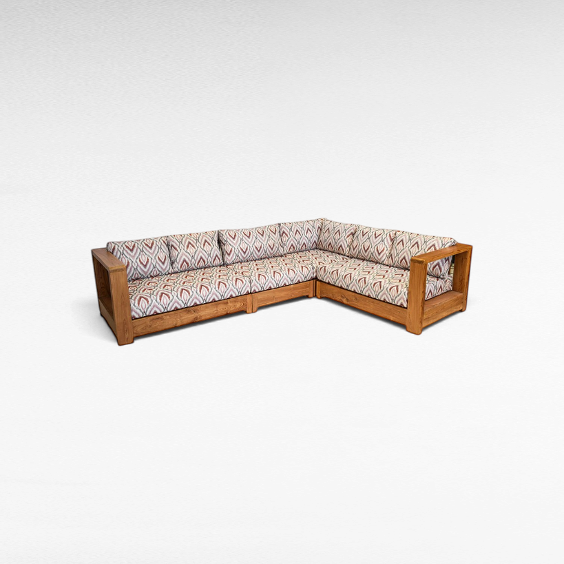 Chora Barefoot Luxury Living teak wood L-shaped sectional sofa with patterned cushions in a warm wood finish