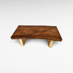 Chora Barefoot Luxury Living coffee table made from natural suar wood with a live edge top and sturdy wooden legs.