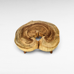 Chora Barefoot Luxury Living suar wood coffee table with a natural live edge round slab top and short wooden legs