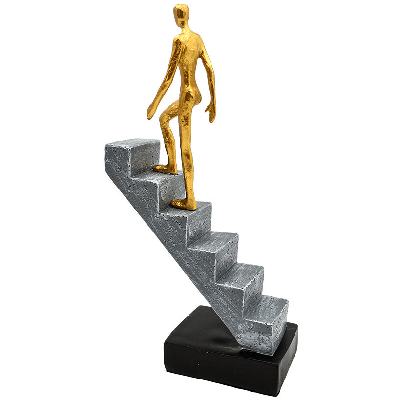 GOLD FIGURINE ON STAIRS