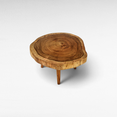Chora Barefoot Luxury Living round live edge wood coffee table with natural grain and three sturdy wooden legs