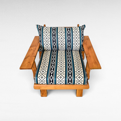 Chora Barefoot Luxury Living teak wood sofa chair with blue and white geometric patterned cushions