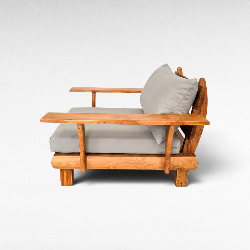 Chora Barefoot Luxury Living teak wood armchair with grey cushions, featuring a natural wood grain and armrests.