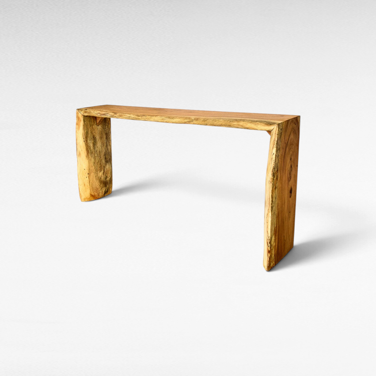 Chora Barefoot Luxury Living natural teak wood console table with a live edge design and minimalist silhouette.
