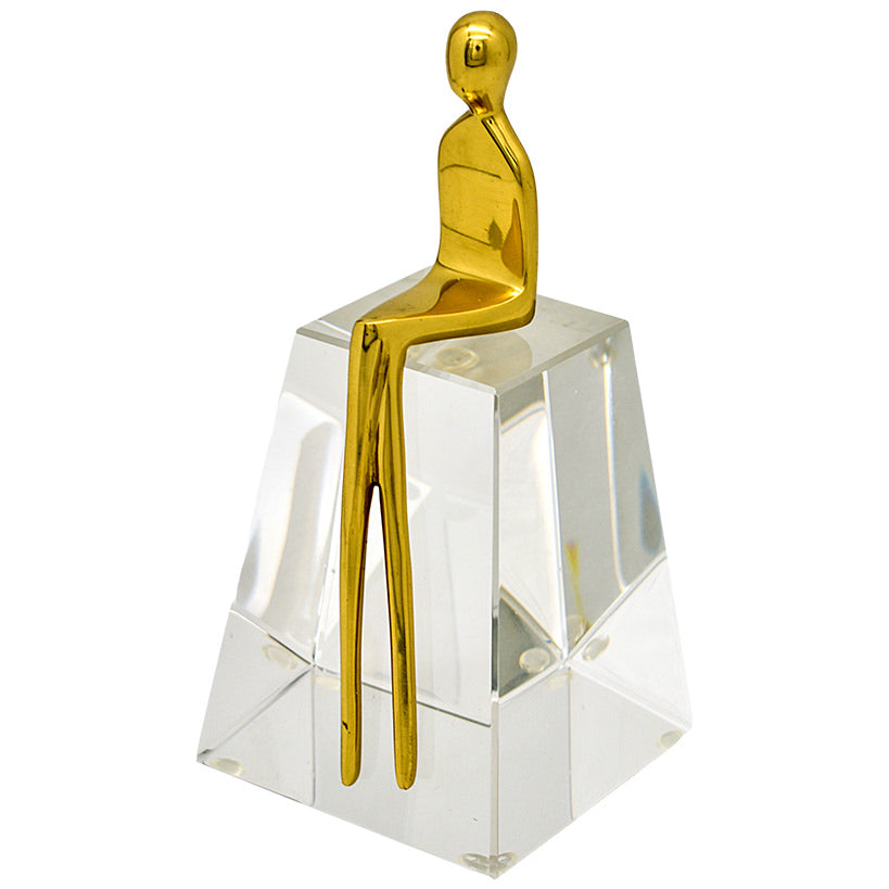 GOLD METAL FIGURINE SITTING IN CLEAR STAND