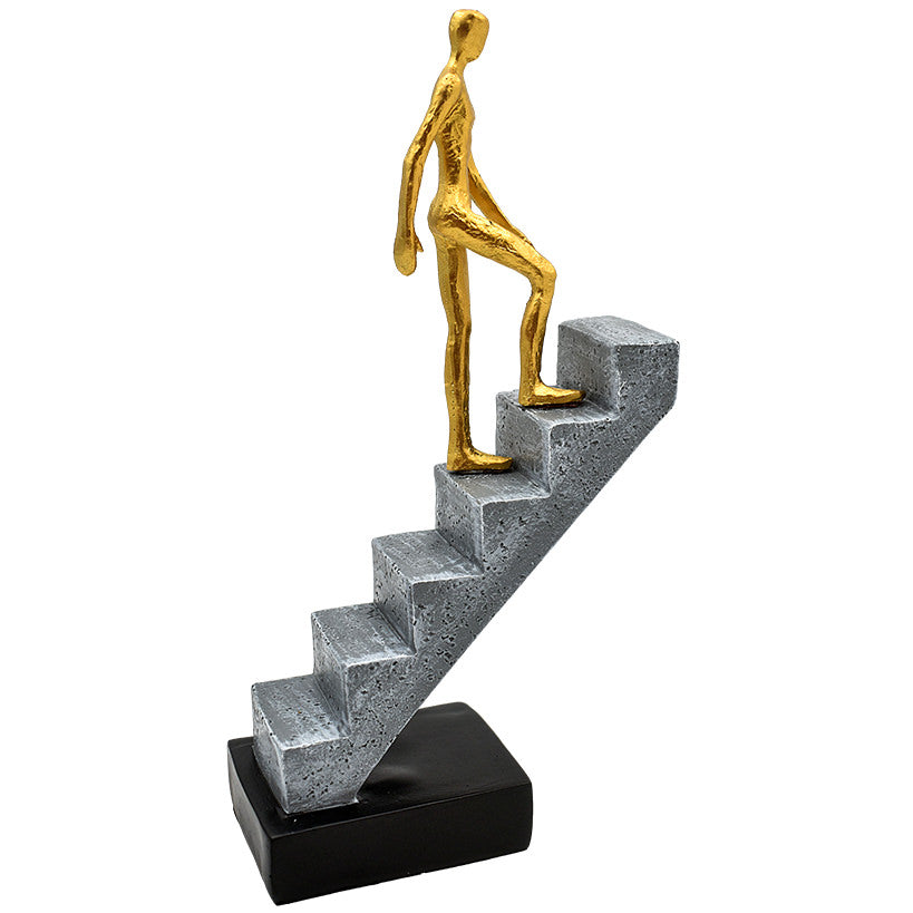 GOLD FIGURINE ON STAIRS