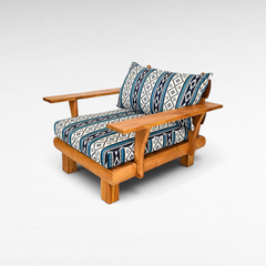 Chora Barefoot Luxury Living teak wood sofa chair with blue and white geometric patterned cushions