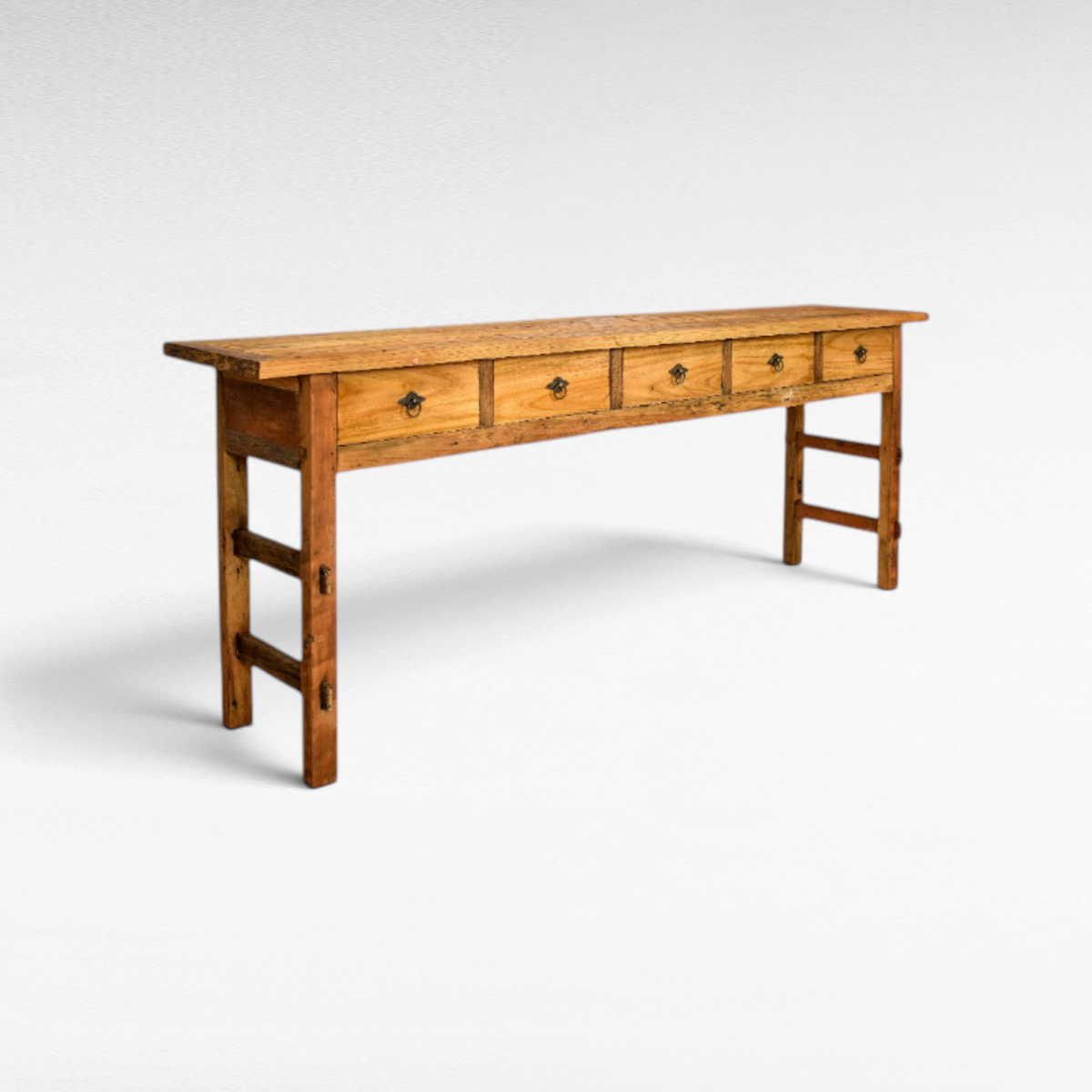 Chora Barefoot Luxury Living rustic teak wood console table featuring five drawers with dark metal ring pulls.