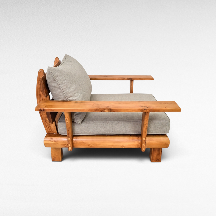Chora Barefoot Luxury Living teak wood armchair with grey cushions, featuring a natural wood grain side profile.