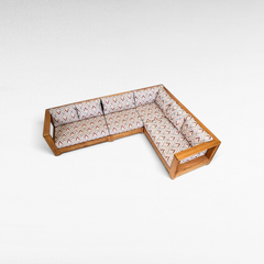 Chora Barefoot Luxury Living teak wood L-shaped sectional sofa with patterned cushions in a high-angle view