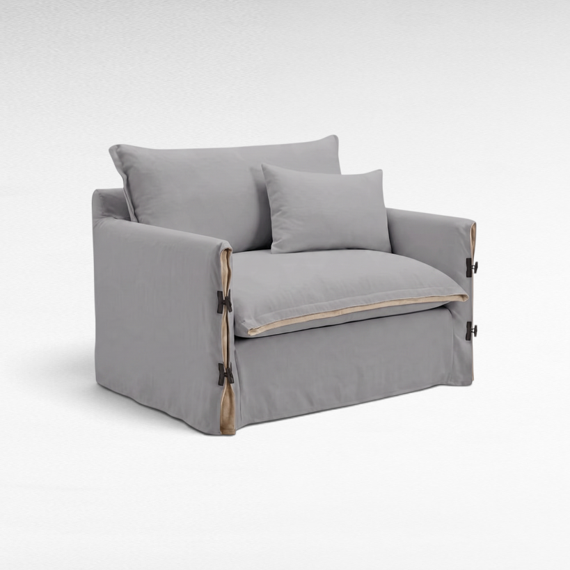 Chora Barefoot Luxury Living two-seater sofa in white linen with side tie details and a matching throw pillow.