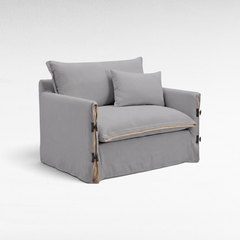 Chora Barefoot Luxury Living two-seater sofa in white linen with side tie details and a matching throw pillow.