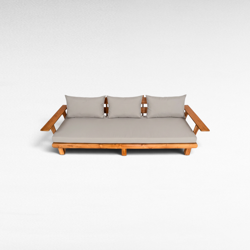 Chora Barefoot Luxury Living teak wood sofa with light grey cushions and wide armrests on a white background