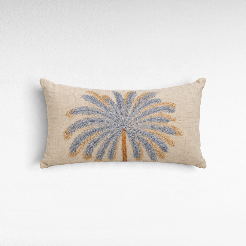 Chora Barefoot Luxury Living rectangular linen pillow featuring an embroidered blue and gold palm tree design.