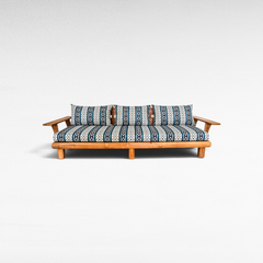 Chora Barefoot Luxury Living teak wood sofa with blue and white patterned cushions on a white background
