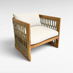 Chora Barefoot Luxury Living teak wood armchair with grey rope weave detailing and plush off-white cushions.