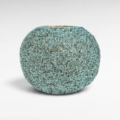 Chora Barefoot Luxury Living light blue and green beaded rattan basket with a textured, artisanal finish.