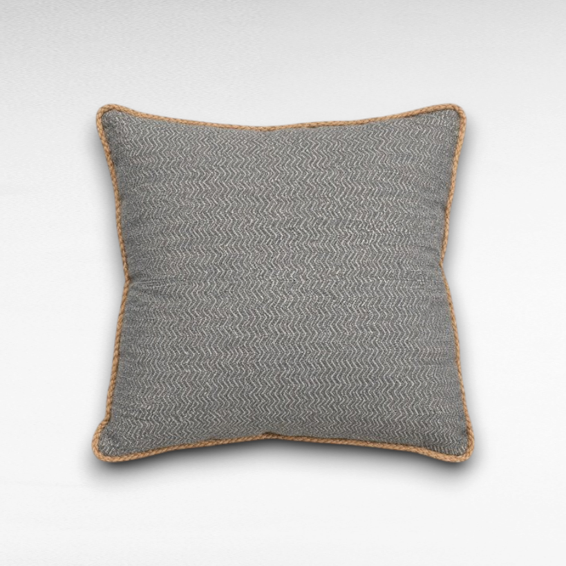 Chora Barefoot Luxury Living grey throw pillow with a textured herringbone pattern and decorative rope trim edging.