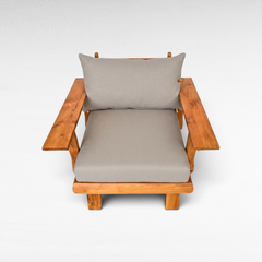 Chora Barefoot Luxury Living teak wood armchair with grey cushions and wide armrests on a white background
