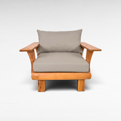 Chora Barefoot Luxury Living teak wood armchair with grey cushions and wide armrests on a white background