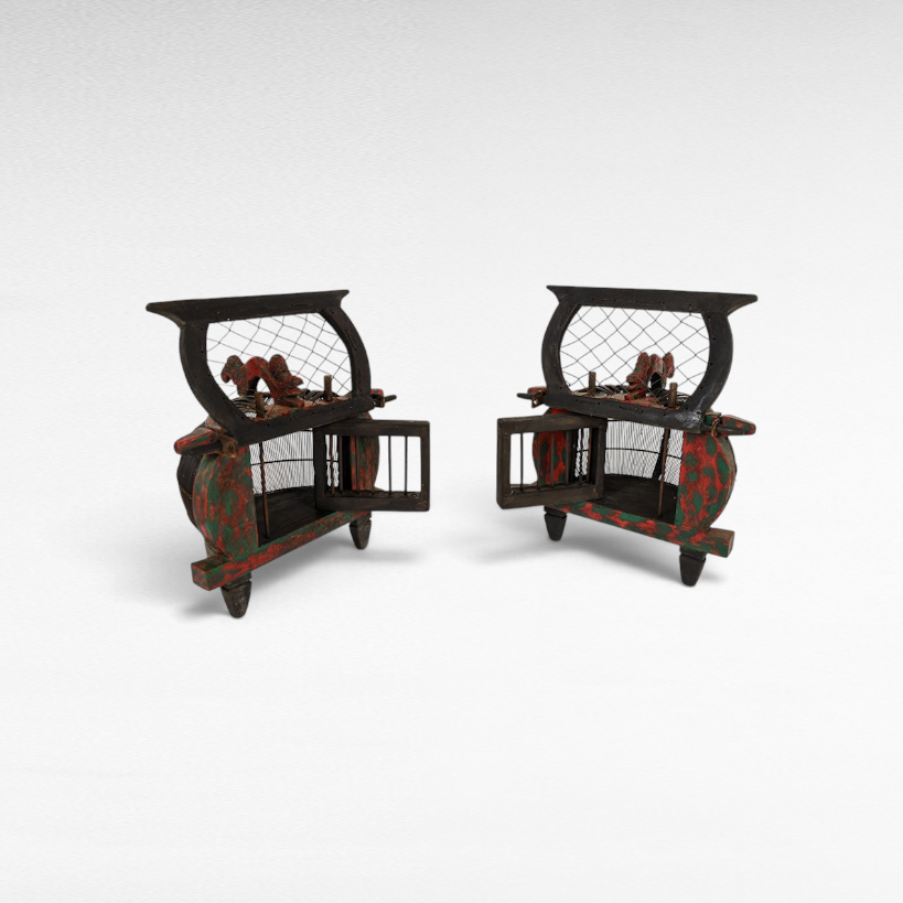 Pair of antique Chora Barefoot Luxury Living bird cages with distressed green and red paint and carved wooden details.