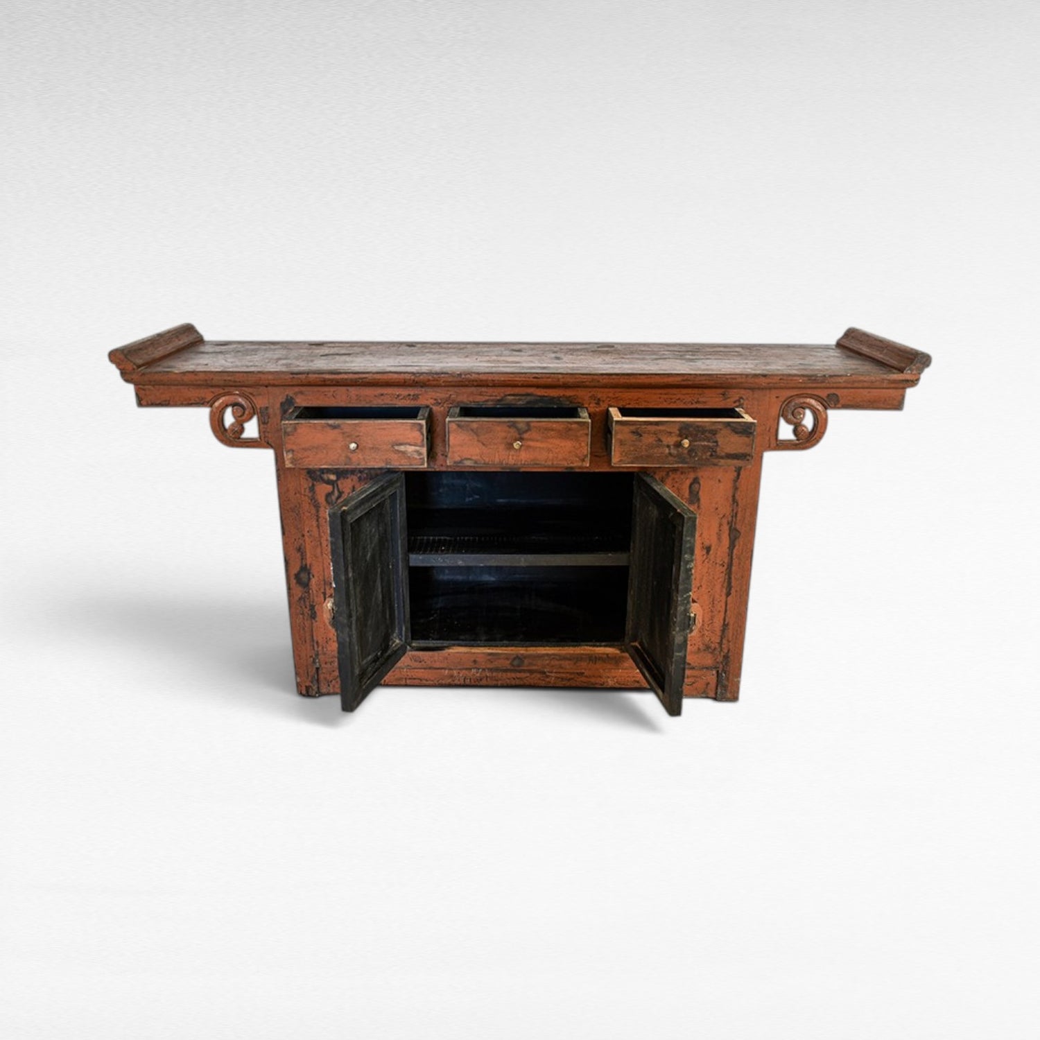 Chora Barefoot Luxury Living antique red distressed wood buffet with three drawers and two open cabinet doors.