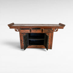 Chora Barefoot Luxury Living antique red distressed wood buffet with three drawers and two open cabinet doors.