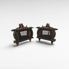 Pair of antique Chora Barefoot Luxury Living bird cages with distressed red and black wooden frames and wire mesh.