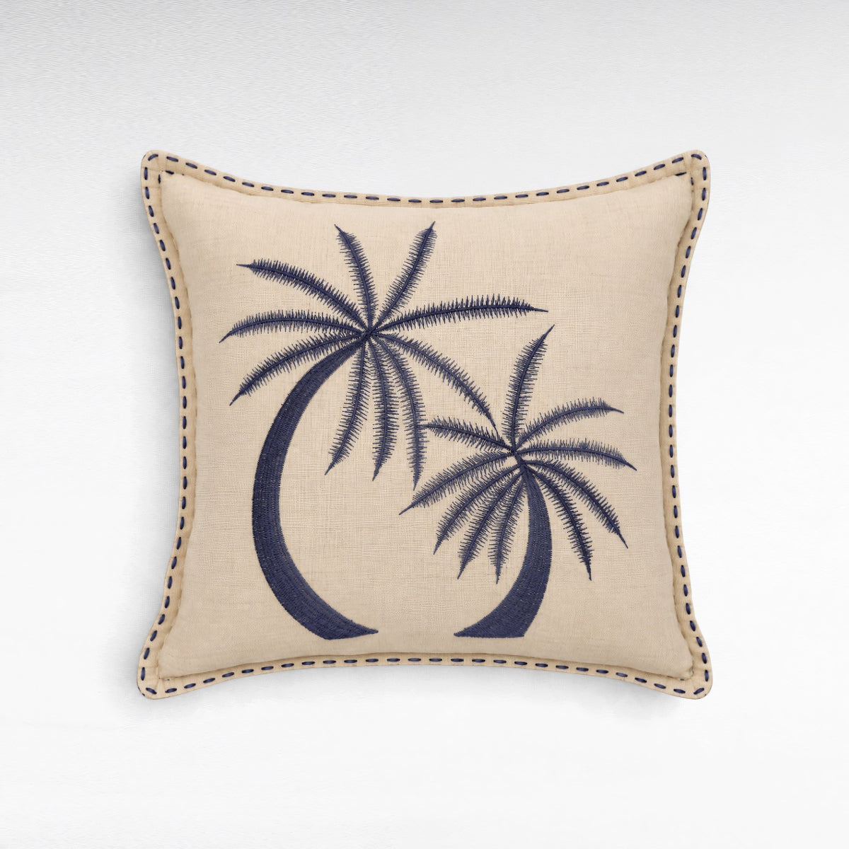Chora Barefoot Luxury Living square beige linen cushion with navy blue embroidered palm tree design and stitched edge