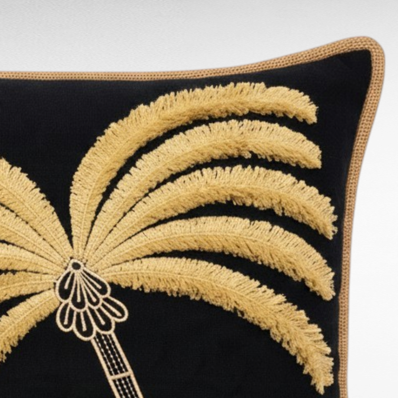 Chora Barefoot Luxury Living square black cushion with an embroidered golden palm tree and natural jute border.