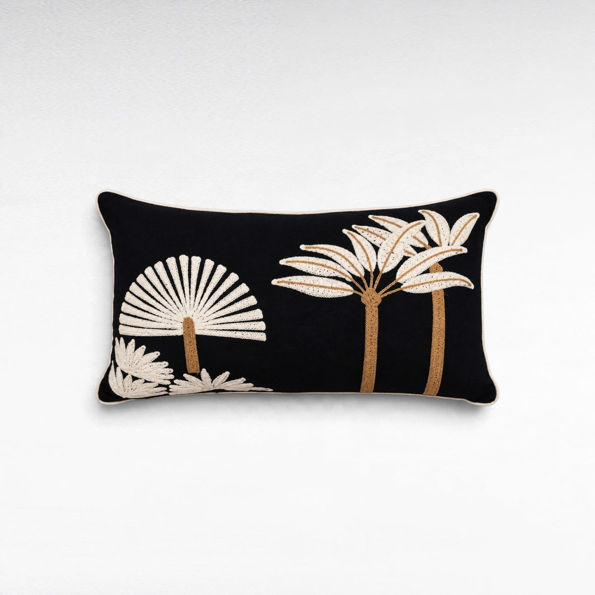 Chora Barefoot Luxury Living rectangular black decorative pillow with white and tan embroidered palm tree motifs