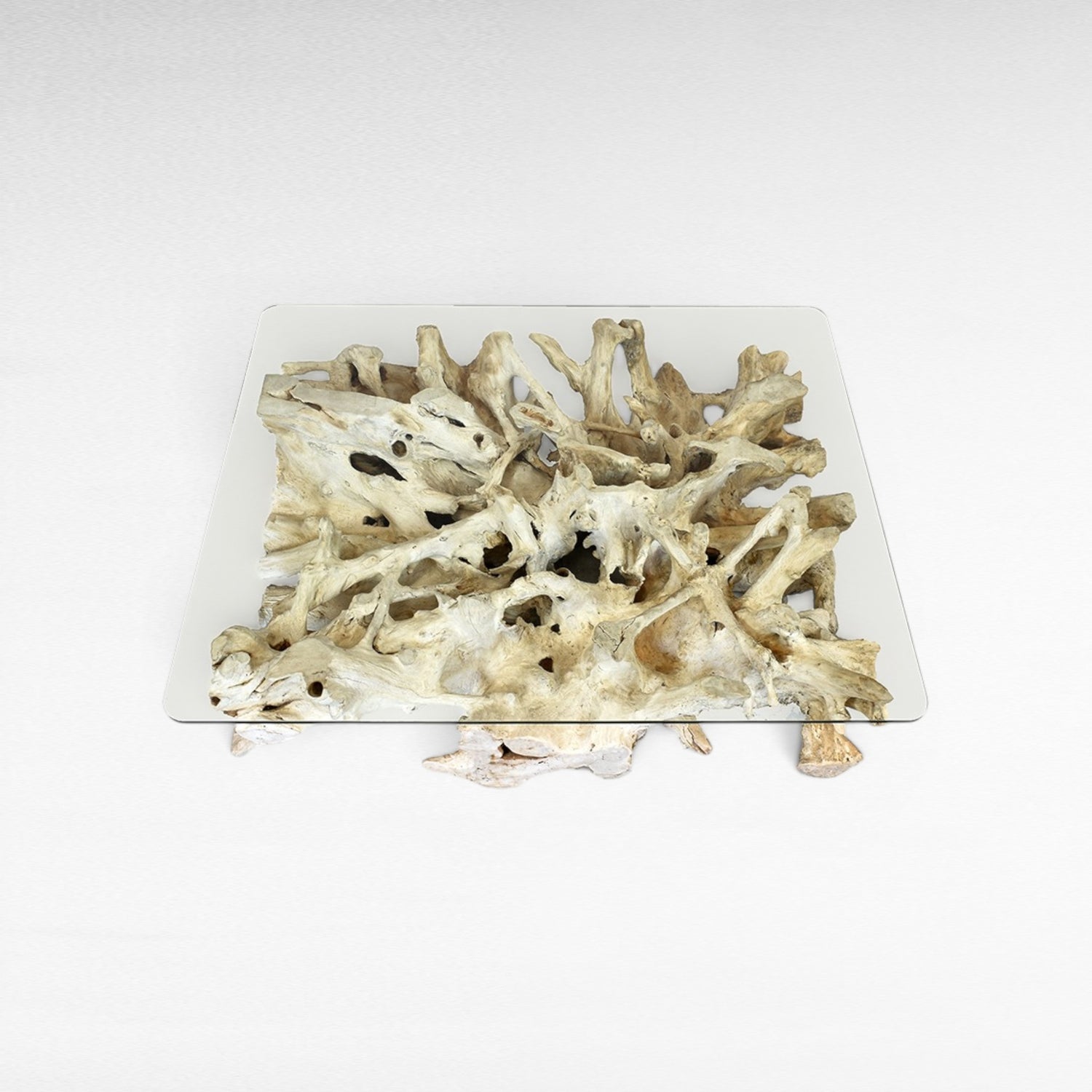 Chora Barefoot Luxury Living bleached driftwood coffee table with clear glass top, organic sculptural base.