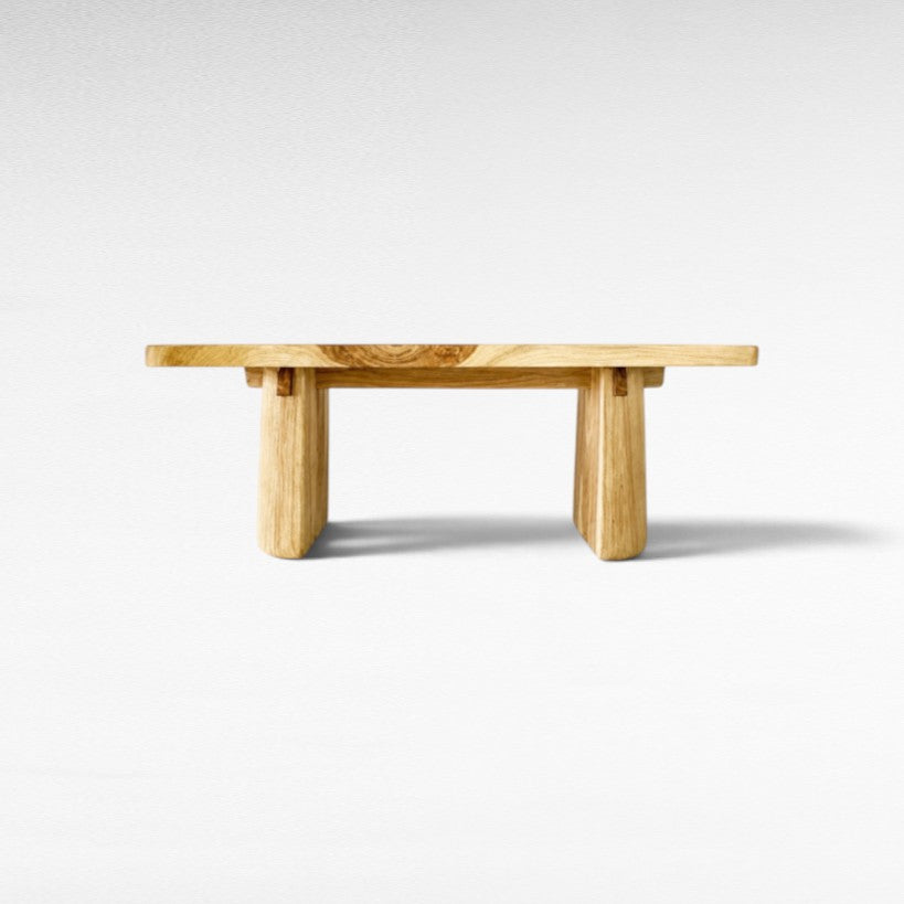 Chora Barefoot Luxury Living bleached suar wood dining table with a natural grain finish and sturdy block legs.
