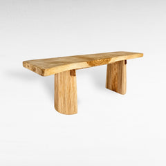 Chora Barefoot Luxury Living bleached suar wood dining table with a natural live edge and sturdy pedestal base.
