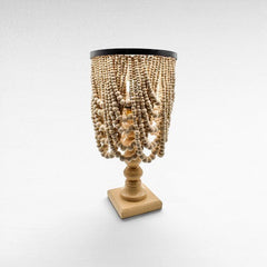 Chora Barefoot Luxury Living bleached wood beaded table lamp with black metal accents and a square base.