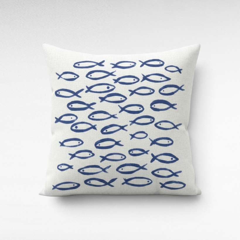 Chora Barefoot Luxury Living square throw pillow featuring a blue hand-painted fish pattern on a white linen fabric.