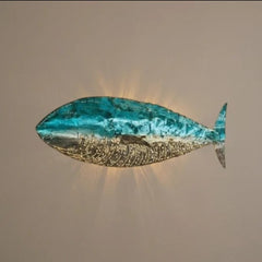 Chora Barefoot Luxury Living blue and silver fish wall lamp with intricate detailing and a serene glow.