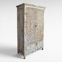 Chora Barefoot Luxury Living distressed white carved wood cupboard with 6 drawers and ornate circular door panel.