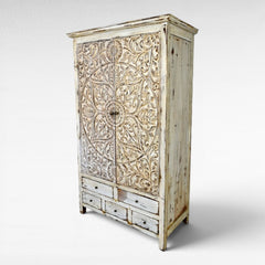 Chora Barefoot Luxury Living distressed white carved wood cupboard with 6 drawers and ornate floral door panels.