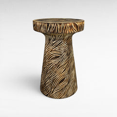 Chora Barefoot Luxury Living carved wood side table with textured wavy pattern, natural wood finish.