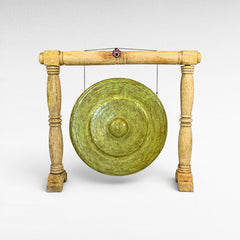 Chora Barefoot Luxury Living ceremonial gong decoration with a distressed green finish, hung on a wooden stand.