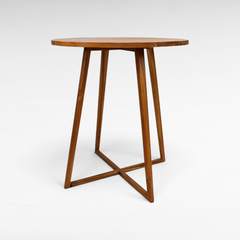 Chora Barefoot Luxury Living circular wooden bar table with a minimalist design and cross-base legs
