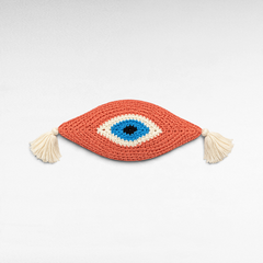 Chora Barefoot Luxury Living cotton eye pillow in coral, blue, white, and black with decorative side tassels.