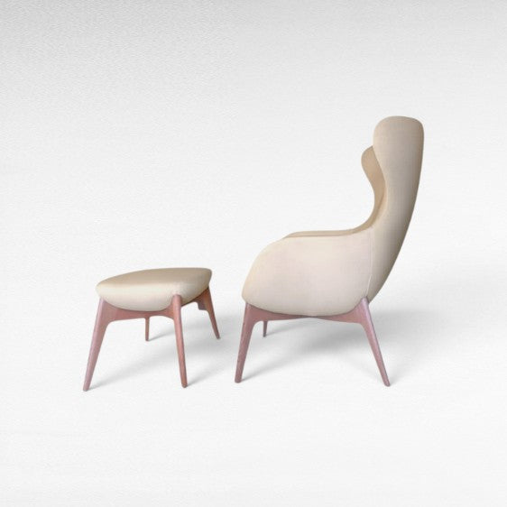 Chora Barefoot Luxury Living cream upholstered wingback chair with oak wood frame and matching ottoman.
