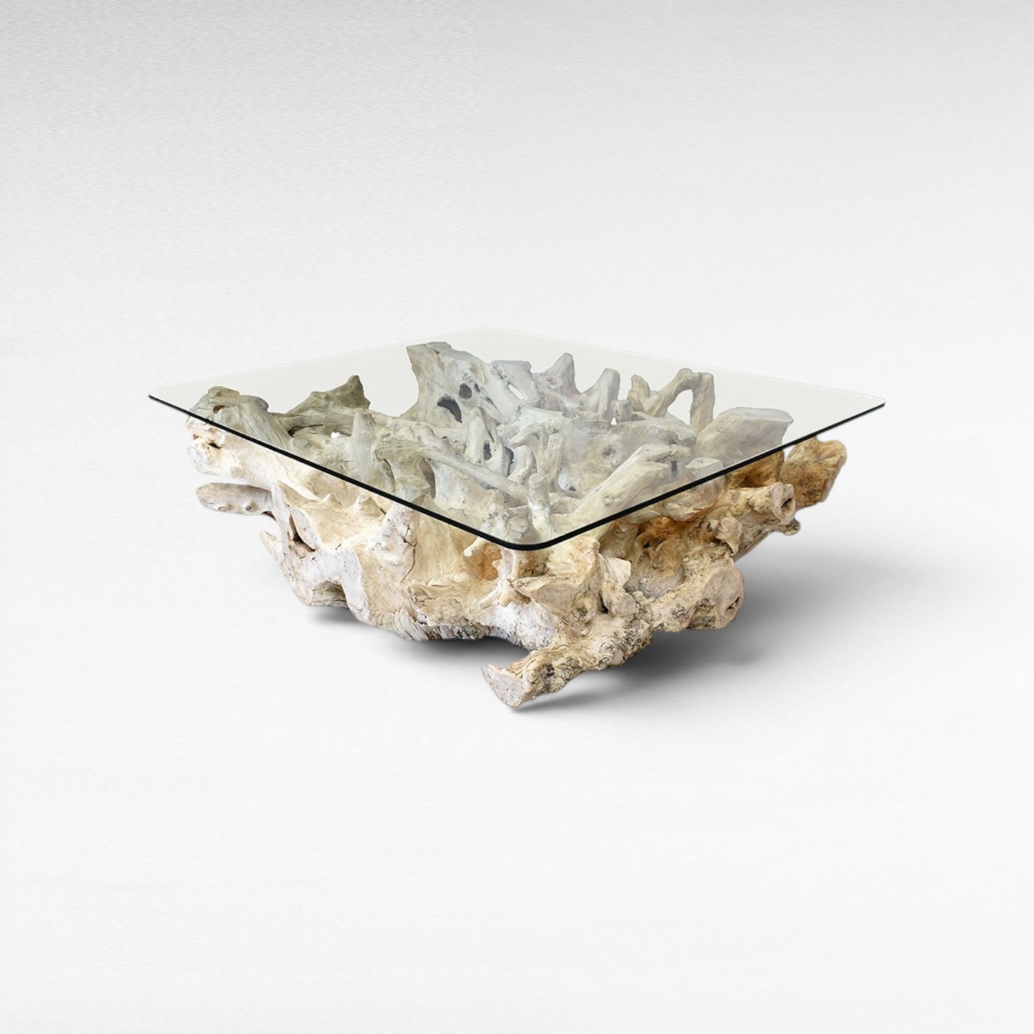Chora Barefoot Luxury Living bleached driftwood coffee table with clear glass top, organic sculptural base.