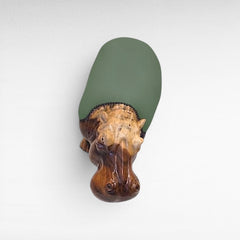 Chora Barefoot Luxury Living hippo stool with a carved wooden head and a smooth olive green upholstered seat.
