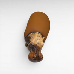 Chora Barefoot Luxury Living hippo stool with a natural wood carved head and smooth brown seat, top view.